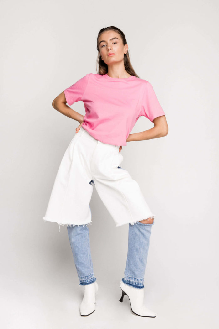 Sustainable fashion label Ksenia Schnaider's Reworked Denim Cutoff Jeans, AKA 'Demi-Denims', are a street style favourite and have a cult following. The two toned jeans are made from secondhand denim, reworked to make a pair of jeans that feature a cut-out at the knee. 
